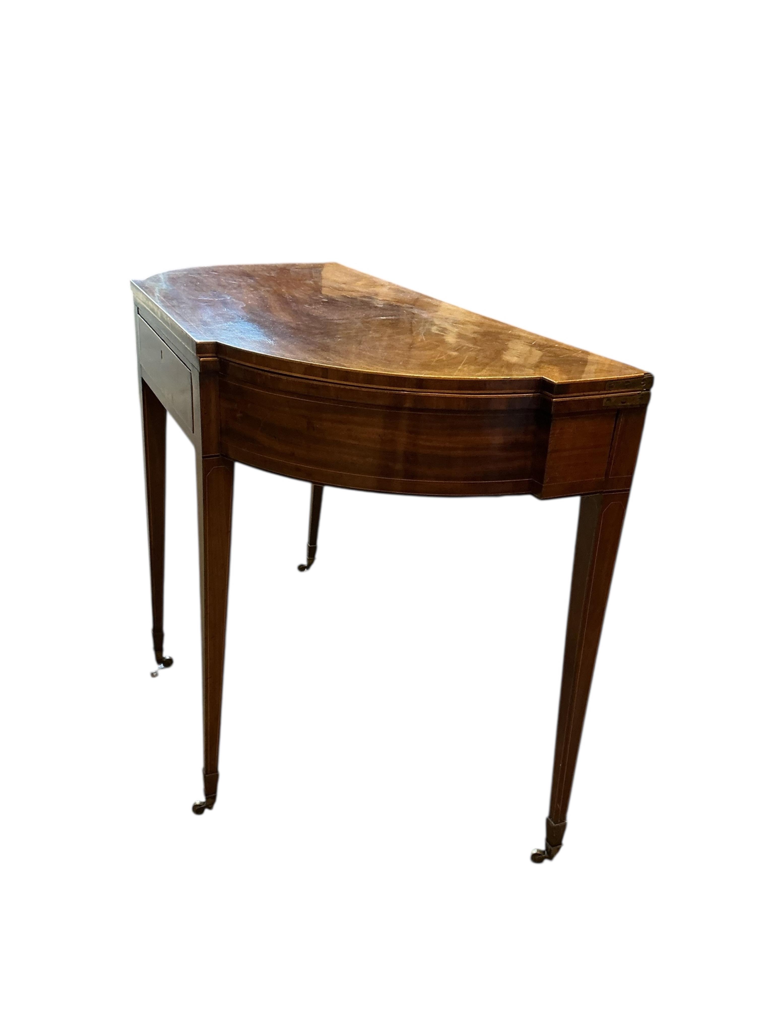 A George III boxwood strung mahogany breakfront folding tea table with frieze drawer, width 101cm, depth 47cm, height 74cm
